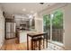 Modern kitchen features stainless steel appliances, wood cabinets and light countertops, and a dining nook at 2138 N Glenarm Pl, Denver, CO 80205