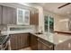 Modern kitchen featuring stainless steel appliances, granite countertops, and sleek cabinetry with a window bringing in natural light at 2138 N Glenarm Pl, Denver, CO 80205