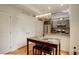 Kitchen features a dining nook with a modern light fixture, as well as stainless steel appliances at 2138 N Glenarm Pl, Denver, CO 80205