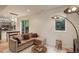 Cozy living room showcases a large sectional couch near the kitchen and a large window with natural light at 2138 N Glenarm Pl, Denver, CO 80205