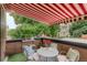Relaxing rooftop patio with a retractable awning, furnished for outdoor dining and entertaining at 2138 N Glenarm Pl, Denver, CO 80205