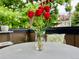 Table with red tulips sitting on a furnished patio area at 2138 N Glenarm Pl, Denver, CO 80205