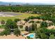 Attractive aerial view of community amenities including a swimming pool, tennis court, and city park at 7373 E Iowa Ave # 1124, Denver, CO 80231