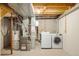 Unfinished basement laundry and utility area with exposed ductwork at 7373 E Iowa Ave # 1124, Denver, CO 80231