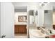 Bathroom vanity with granite countertops and a framed mirror at 7373 E Iowa Ave # 1124, Denver, CO 80231