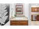 Stylish bathroom with wooden cabinets, granite countertops, and modern decor at 7373 E Iowa Ave # 1124, Denver, CO 80231