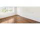 Bright bedroom featuring hardwood floors and a window with a view at 7373 E Iowa Ave # 1124, Denver, CO 80231