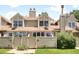 Well-maintained home featuring a manicured lawn, secure fenced yard, and welcoming entryway at 7373 E Iowa Ave # 1124, Denver, CO 80231