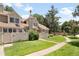 Charming two-story home boasts a lush front yard, manicured landscaping, and a welcoming walkway at 7373 E Iowa Ave # 1124, Denver, CO 80231