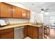 Updated kitchen with stainless steel dishwasher, granite counters and wooden cabinets at 7373 E Iowa Ave # 1124, Denver, CO 80231