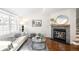 Cozy living room features a fireplace, plush seating, and plenty of natural light from the large windows at 7373 E Iowa Ave # 1124, Denver, CO 80231
