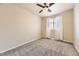 Bedroom featuring plush carpet, a modern ceiling fan, and window with plenty of light at 11302 Tumbleweed Way, Parker, CO 80138