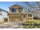 Charming two-story home features a two-car garage and inviting curb appeal on a sunny day at 11302 Tumbleweed Way, Parker, CO 80138