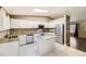 Bright kitchen featuring white cabinets, stainless steel appliances, and a granite island at 11302 Tumbleweed Way, Parker, CO 80138