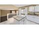 Stylish kitchen showcasing granite island, white cabinets, and a breakfast nook at 11302 Tumbleweed Way, Parker, CO 80138