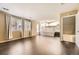 Spacious living room with hardwood floors, leading to an open-concept kitchen at 11302 Tumbleweed Way, Parker, CO 80138