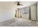 Comfortable main bedroom featuring a ceiling fan, plush carpet, and an ensuite bathroom at 11302 Tumbleweed Way, Parker, CO 80138