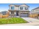 Charming two-story home featuring a two-car garage, well-kept lawn, and neutral-tone siding at 1907 Mount Monroe Dr, Berthoud, CO 80513