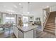Open kitchen with a center island, stainless steel dishwasher, and seamless flow into the dining and living areas at 1907 Mount Monroe Dr, Berthoud, CO 80513