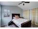 Bright main bedroom featuring a ceiling fan, a window, and decorative curtains at 11610 Hooker St, Westminster, CO 80031