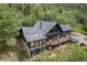 Aerial view of mountain home, featuring a deck with seating, mature trees and privacy at 239 Aspen Pl, Evergreen, CO 80439