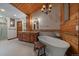 Bathroom featuring wood cabinets, double vanity, soaking tub, and glass shower at 239 Aspen Pl, Evergreen, CO 80439