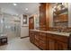 Bathroom with double vanity, tile floors and luxurious walk-in shower with bench seat at 239 Aspen Pl, Evergreen, CO 80439