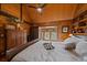 Cozy bedroom featuring vaulted wood ceilings, built-in shelving and bright windows at 239 Aspen Pl, Evergreen, CO 80439