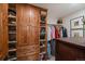 Walk-in closet featuring custom built-in shelving and ample storage space for shoes and clothes at 239 Aspen Pl, Evergreen, CO 80439