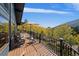 Relaxing deck space features a mountain view and outdoor seating with a lovely railing at 239 Aspen Pl, Evergreen, CO 80439