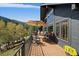 Enjoy outdoor living on this expansive deck with ample seating and scenic views of nature at 239 Aspen Pl, Evergreen, CO 80439