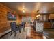 Charming dining area with wood paneled walls, a stone island, and a door to the outside at 239 Aspen Pl, Evergreen, CO 80439