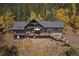 Stunning mountain home with a large deck for enjoying the surrounding wooded views in the fall at 239 Aspen Pl, Evergreen, CO 80439