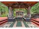 Outdoor gazebo with fireplace, ceiling fan, and comfortable seating for ultimate relaxation at 239 Aspen Pl, Evergreen, CO 80439