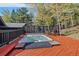Relaxing hot tub on a spacious deck with scenic views and privacy fencing with nature scene at 239 Aspen Pl, Evergreen, CO 80439