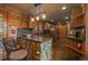Cozy kitchen featuring stone countertops, wooden cabinets, stainless steel appliances, and bar seating at 239 Aspen Pl, Evergreen, CO 80439