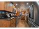 Modern kitchen featuring wood cabinets, granite countertops, stainless steel appliances, and tile flooring at 239 Aspen Pl, Evergreen, CO 80439