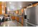 Well-lit kitchen featuring granite countertops and stainless steel appliances with an adjoining dining area at 239 Aspen Pl, Evergreen, CO 80439