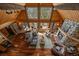 Aerial view of living room boasting vaulted ceilings, stone fireplace, hardwood floors, and mountain views at 239 Aspen Pl, Evergreen, CO 80439