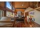 Spacious living room featuring hardwood floors, stone fireplace, vaulted ceilings and large windows at 239 Aspen Pl, Evergreen, CO 80439
