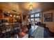 Cozy living room with a stone bar, hardwood floors, and large windows with great views at 239 Aspen Pl, Evergreen, CO 80439