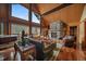 Inviting living room with a stone fireplace, wood floors, and comfortable seating, with lots of natural light at 239 Aspen Pl, Evergreen, CO 80439