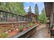 Stone patio features lush landscaping, and hot tub gazebo ideal for outdoor relaxation at 239 Aspen Pl, Evergreen, CO 80439