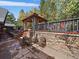 Charming outdoor patio with stone walls, perfect for relaxing and enjoying the serene surroundings at 239 Aspen Pl, Evergreen, CO 80439