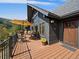Inviting covered porch with seating area, wooden floors, and mountain views, perfect for enjoying the outdoors at 239 Aspen Pl, Evergreen, CO 80439