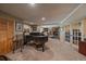 Spacious rec room with a piano, drum set, and stone fireplace, offering a versatile entertainment area at 239 Aspen Pl, Evergreen, CO 80439