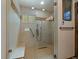 Modern walk-in shower with glass enclosure, bench, and tiled walls provides a spa-like experience at 239 Aspen Pl, Evergreen, CO 80439