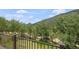 Balcony view showcasing a lush mountain landscape and mature trees in a serene setting at 239 Aspen Pl, Evergreen, CO 80439