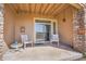 Covered back porch featuring two chairs and a small table at 9538 W San Juan Cir # 104, Littleton, CO 80128