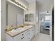 Bathroom boasts double sinks, and view of the bedroom at 9538 W San Juan Cir # 104, Littleton, CO 80128
